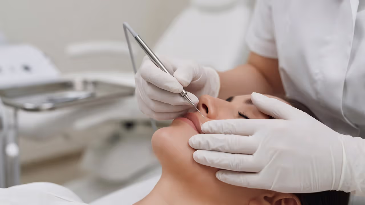 Electrologist performing a facial hair removal session on a client