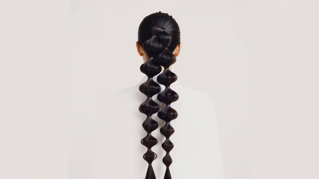 Bubble ponytail hairstyle with multiple elastics creating rounded sections