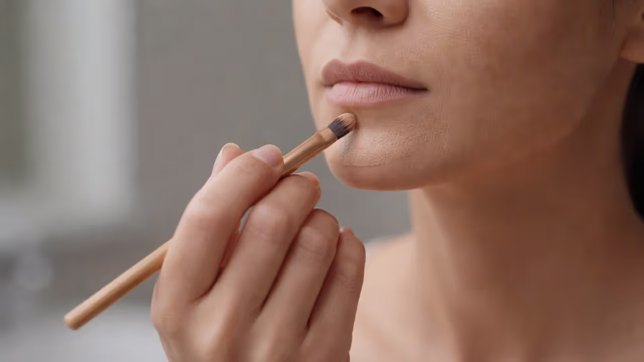 Makeup contouring technique applied to the chin area to minimize a cleft chin